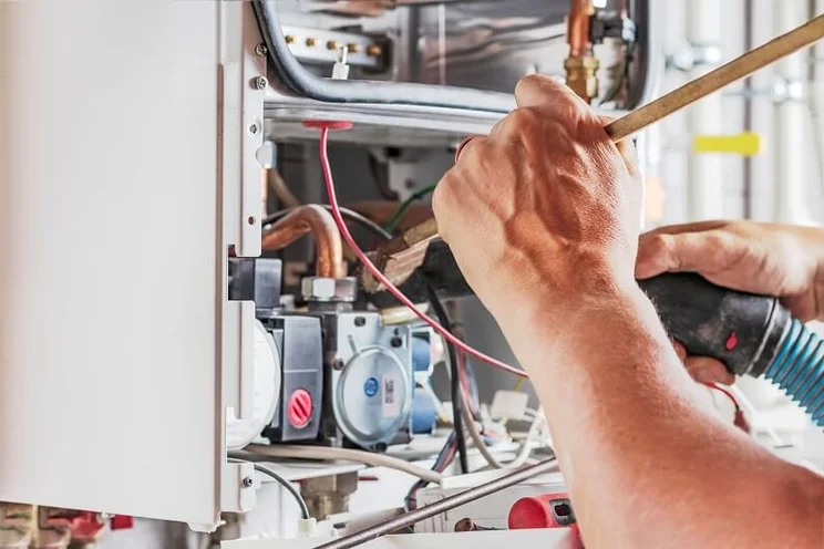 person servicing a boiler 1